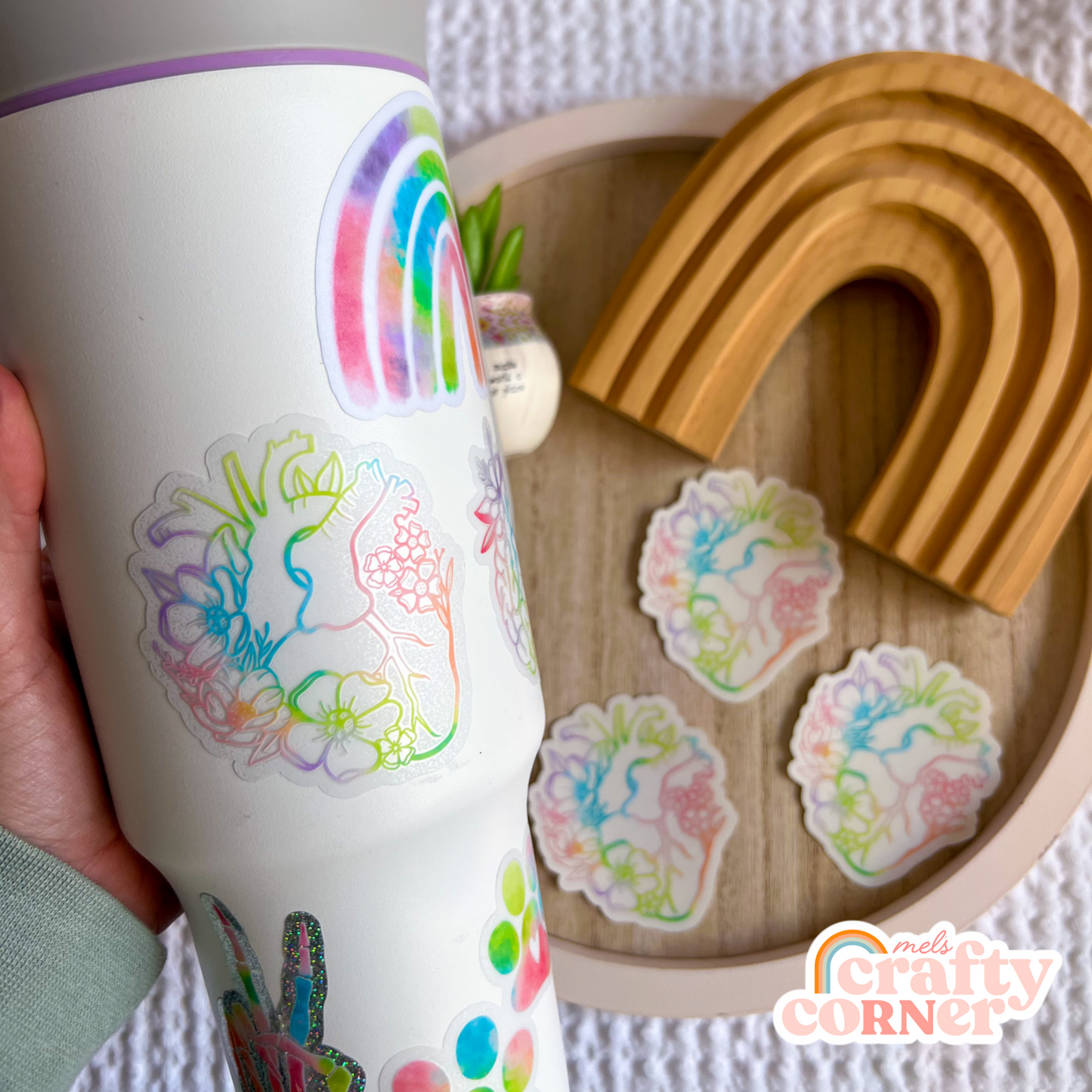 Hand holding Floral Anatomical Heart colorful clear sticker showing size and scale by Mel's Crafty Corner