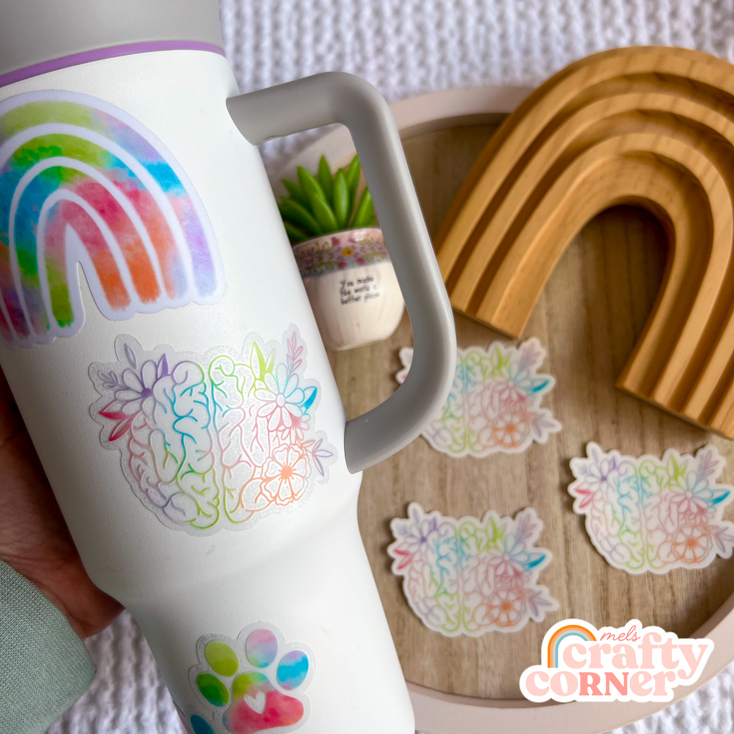 Hand holding Floral Anatomical Brain colorful clear sticker showing size and scale by Mel's Crafty Corner