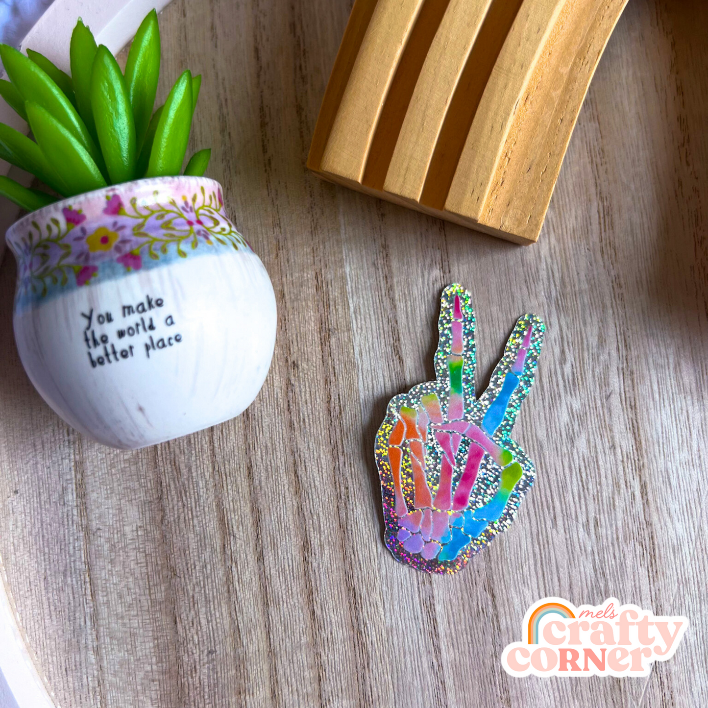 Hand holding Skeleton Peace Sign holographic sticker showing size and scale by Mel's Crafty Corner