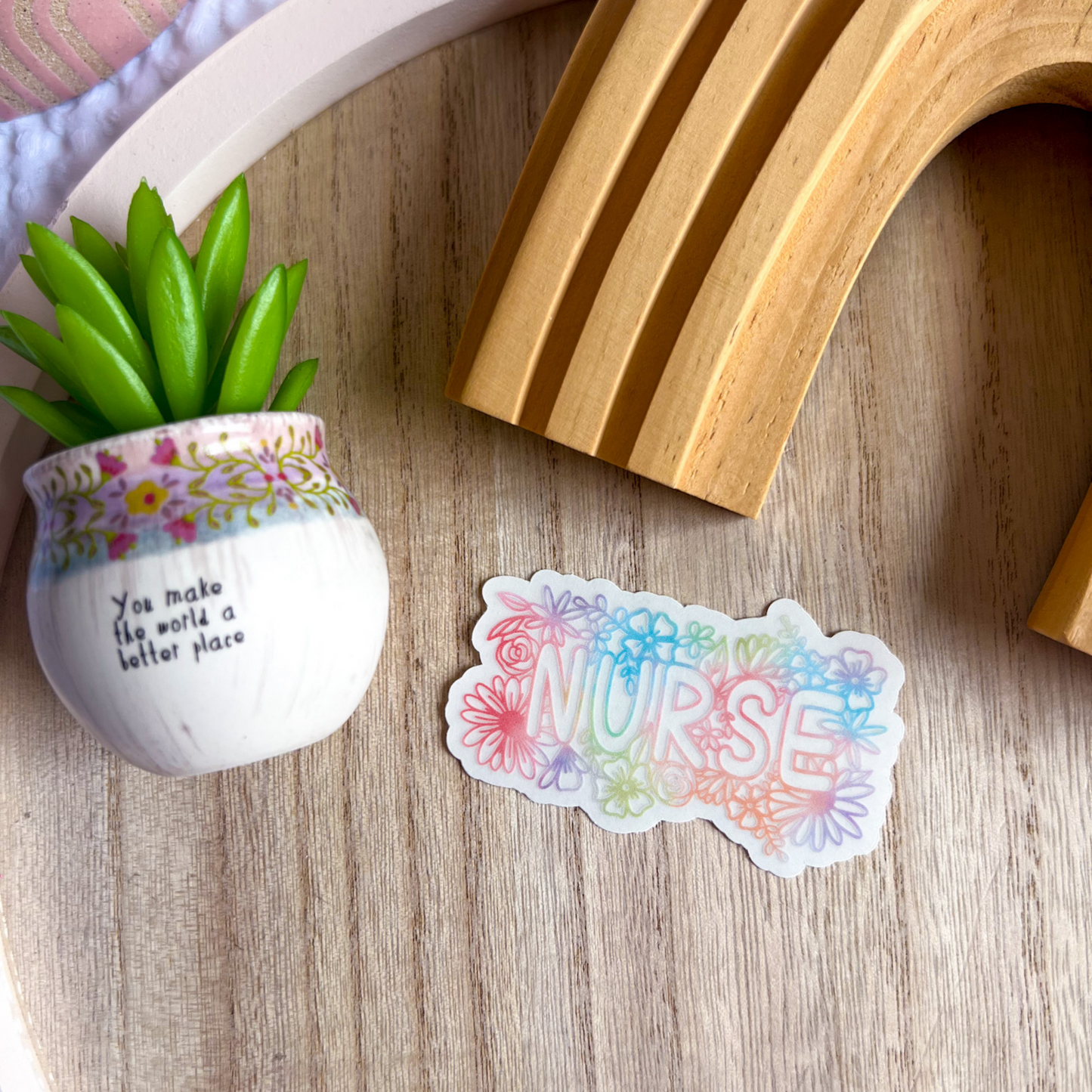 Hand holding Floral Nurse colorful clear sticker showing size and scale by Mel's Crafty Corner