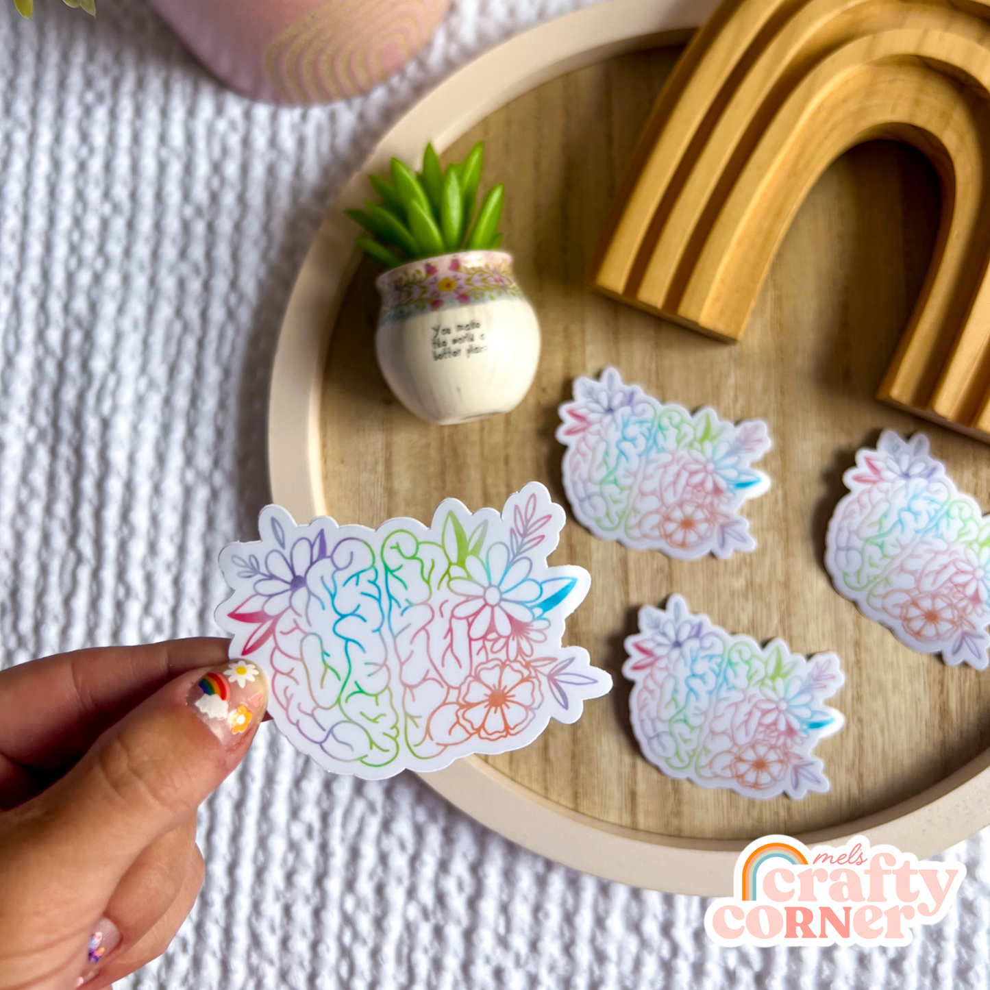 Hand holding Floral Anatomical Brain colorful matte sticker showing size and scale by Mel's Crafty Corner