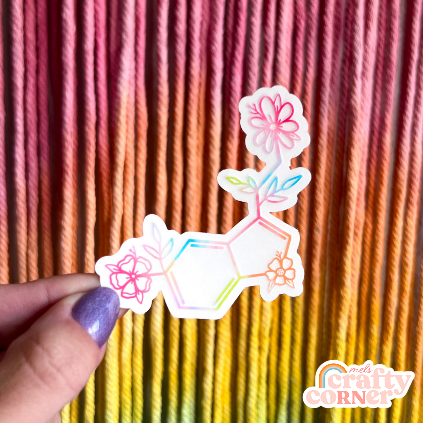 Hand holding Floral Serotonin colorful clear sticker showing size and scale by Mel's Crafty Corner