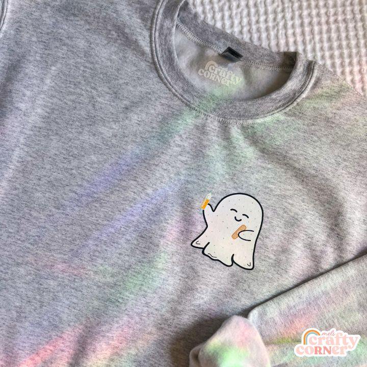 Flat lay view of ash gray Boo-Boo Ghostie classic crewneck sweatshirt by Mel's Crafty Corner