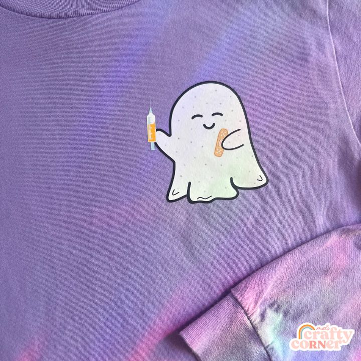 Flat lay view of the Boo-Boo Ghostie soft long sleeve shirt by Mel's Crafty Corner