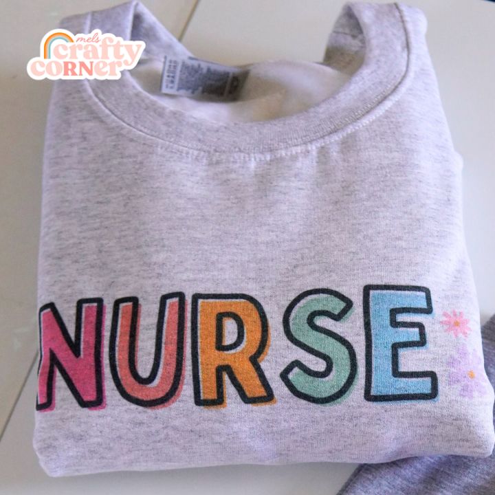 Folded view of Colorful Nurse classic crewneck sweatshirt by Mel's Crafty Corner