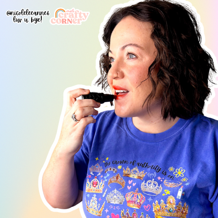 Women applying makeup, wearing Crown of Authority t-shirt