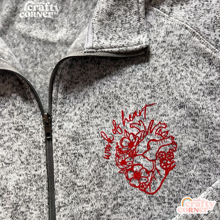 Flat lay view of heather grey Floral Anatomical Heart (WOH) fleece zip-up jacket by Mel's Crafty Corner
