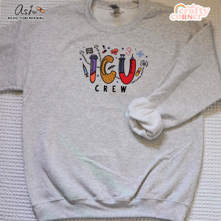 Second view of ICU Crew Merch ash gray crewneck sweatshirt showing design details by Mel's Crafty Corner