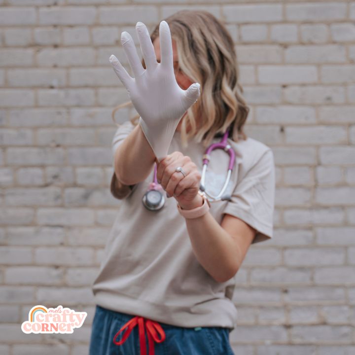 Alternative pose of Mel modeling Pocket Floral Nurse T-Shirt