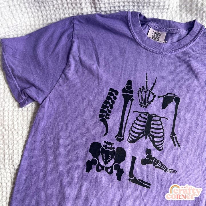Flat lay view of violet Build Your Boneyard premium t-shirt by Mel's Crafty Corner