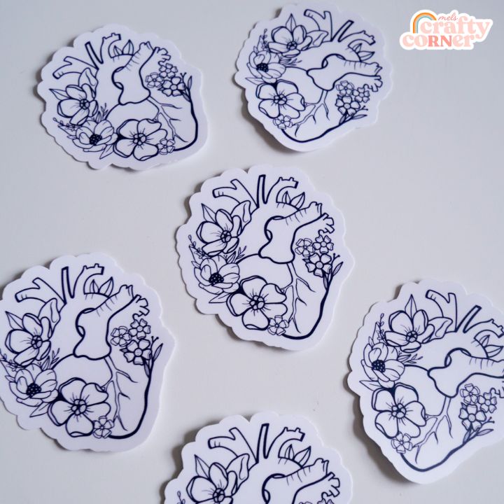 Hand holding Floral Anatomical Heart black matte sticker showing size and scale by Mel's Crafty Corner