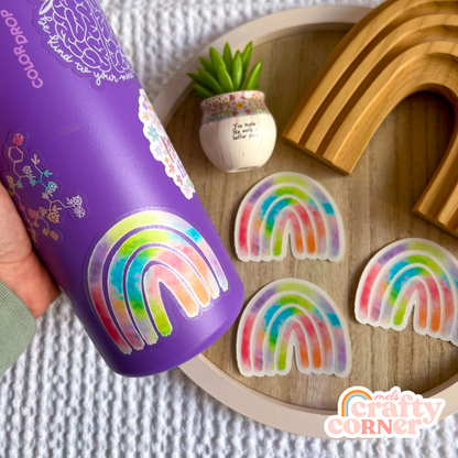 Hand holding Rainbow colorful clear sticker showing size and scale by Mel's Crafty Corner