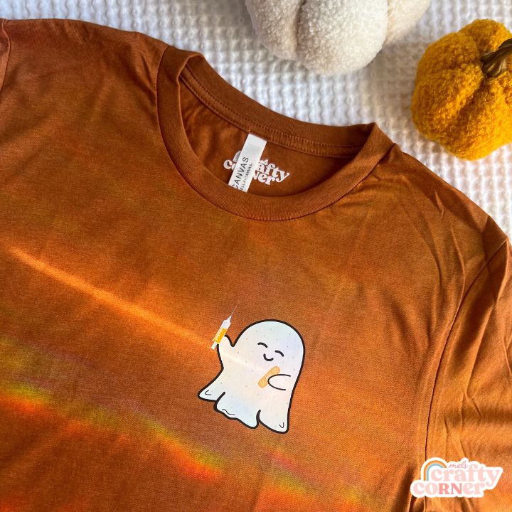 Flat lay view of heather autumn Boo-Boo Ghostie softest t-shirt by Mel's Crafty Corner