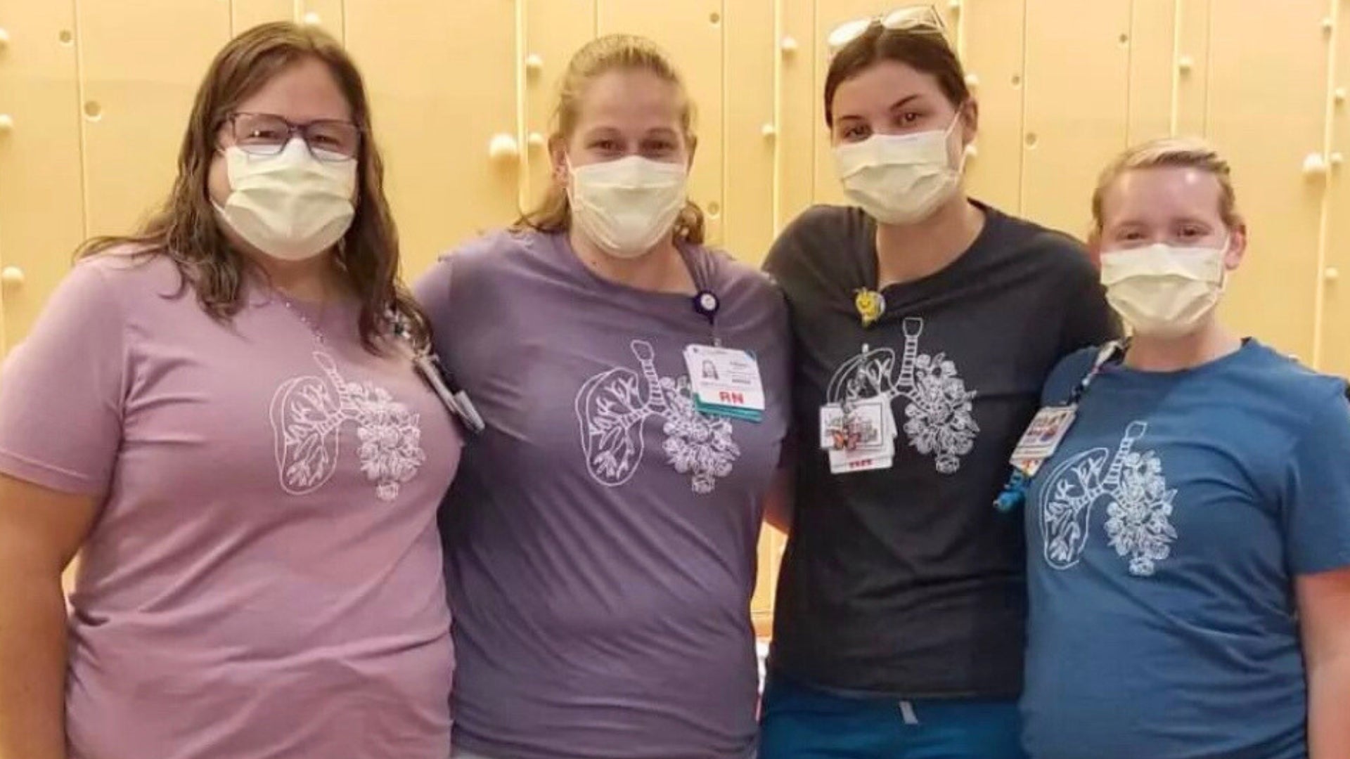 Group or nurses with masks on, wearing custom apparel from Mel's Crafty Corner with floral lung design