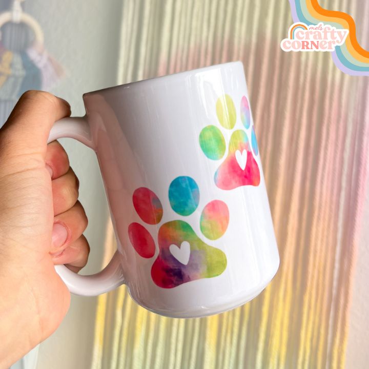 Colorful Paw Print design on 15 oz ceramic mug, main product image by Mel's Crafty Corner