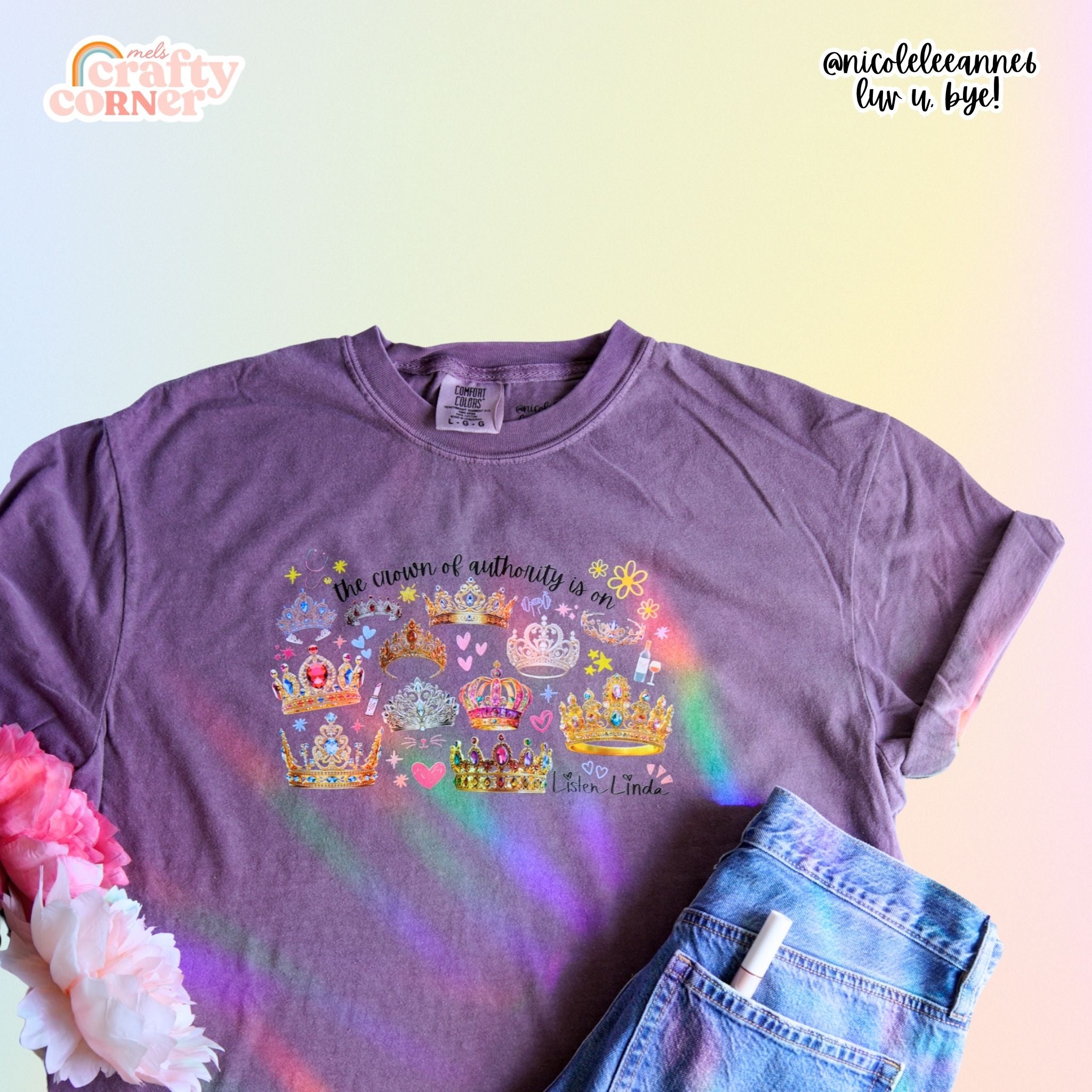 Flat lay of violet wine Crown of Authority T-Shirt by Mel's Crafty Corner