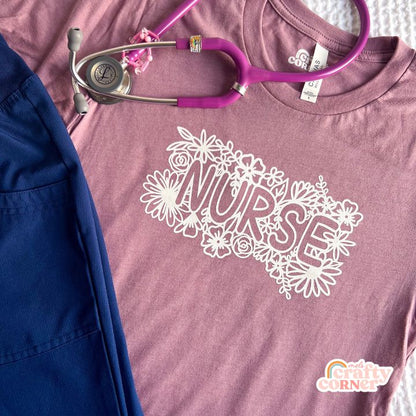 Orchid-colored Floral Nurse soft t-shirt laid flat