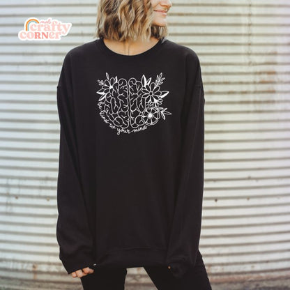 Model wearing black Be Kind To Your Mind classic crewneck with flat lay view by Mel's Crafty Corner