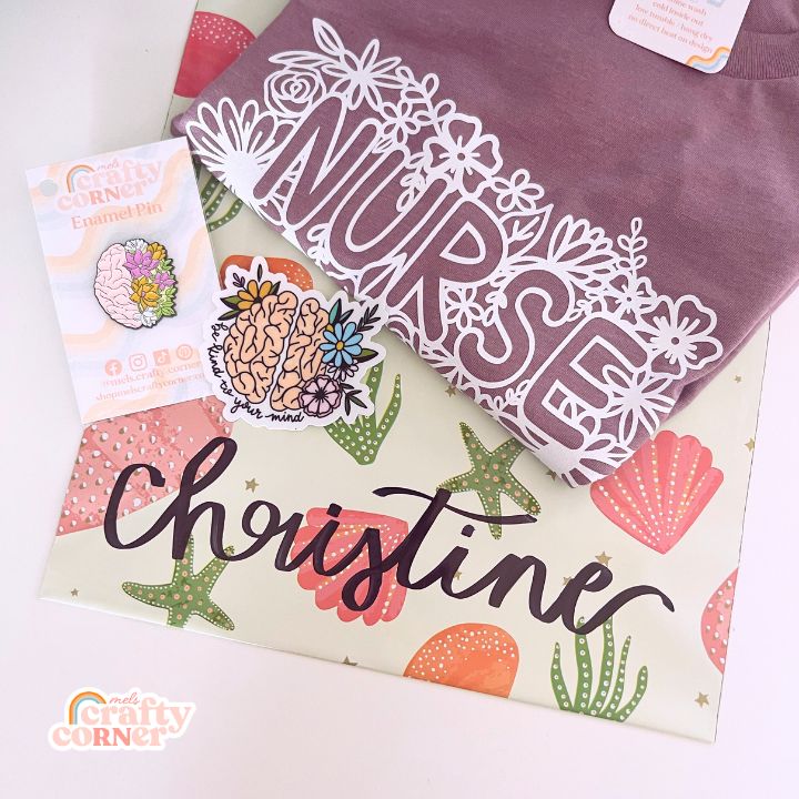 Mel's Crafty Corner Floral Nurse t-shirt packaged as Happy Mail delivery