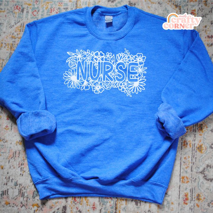 Heather royal blue Floral Nurse Classic Crewneck laid flat