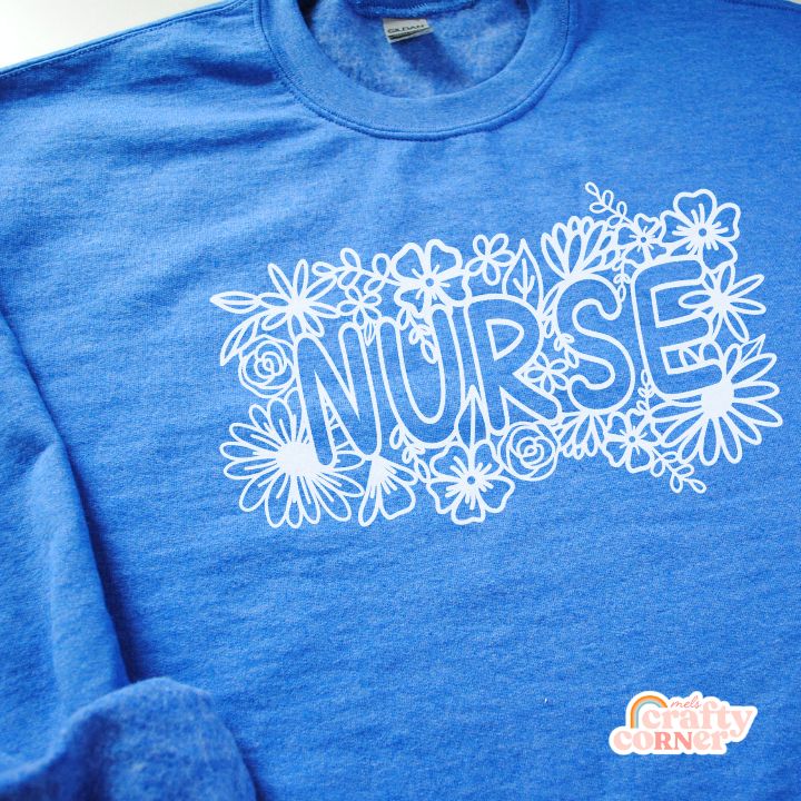 Detailed close-up of heather royal blue Floral Nurse Classic Crewneck