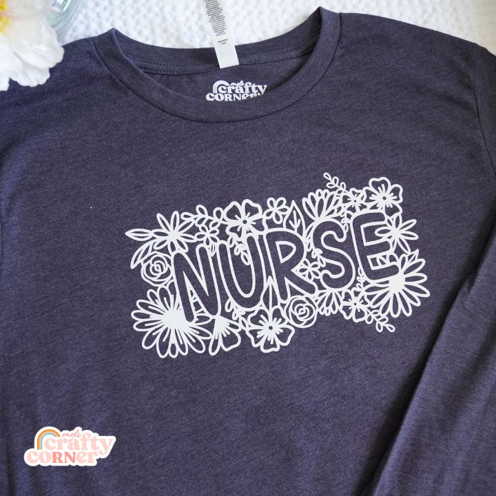 Close-up detail of the Floral Nurse design on soft long sleeve shirt by Mel's Crafty Corner