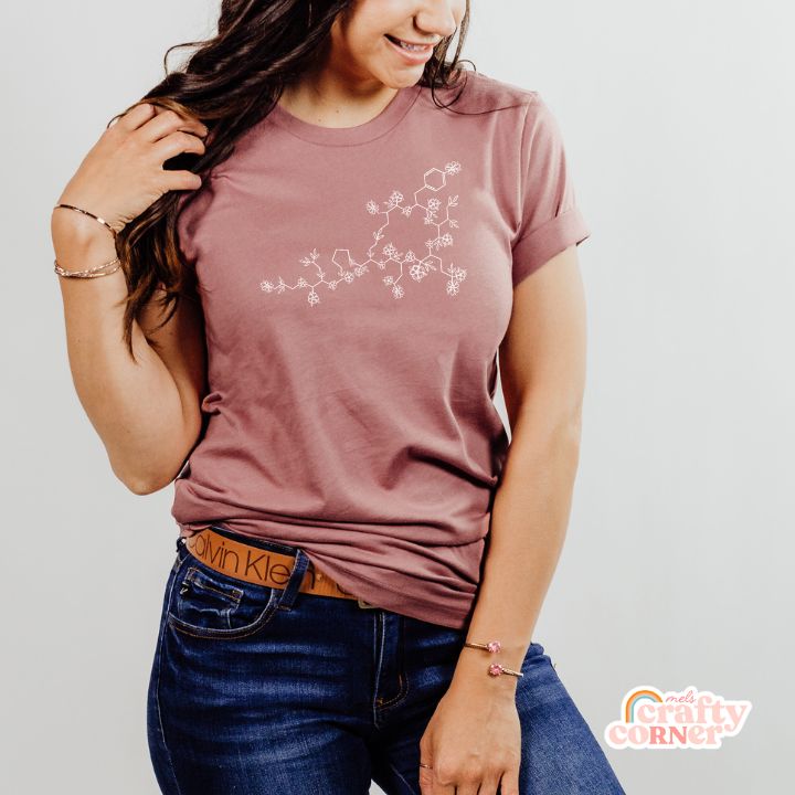 Model wearing Floral Oxytocin soft t-shirt in orchid color
