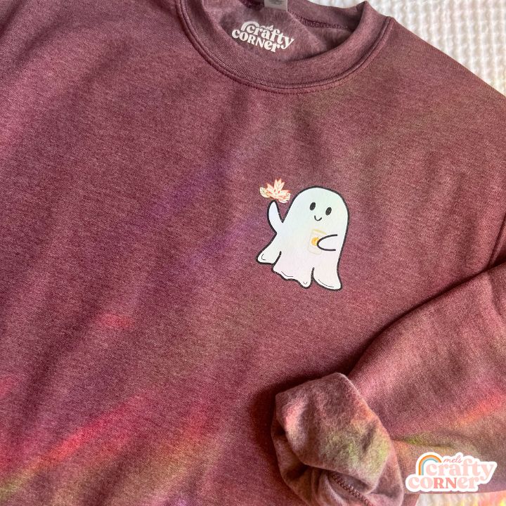 Flat lay view of heather maroon Leaves & Lattes Ghostie classic crewneck sweatshirt by Mel's Crafty Corner