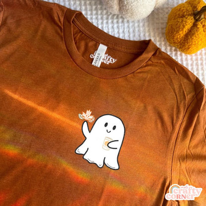 Flat lay view of heather autumn Leaves & Lattes Ghostie softest t-shirt by Mel's Crafty Corner