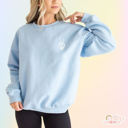 Front view of light blue Build Your Boneyard classic crewneck sweatshirt by Mel's Crafty Corner