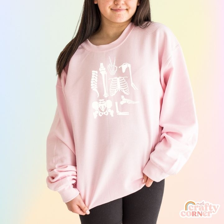 Front view of light pink Build Your Boneyard classic crewneck sweatshirt by Mel's Crafty Corner