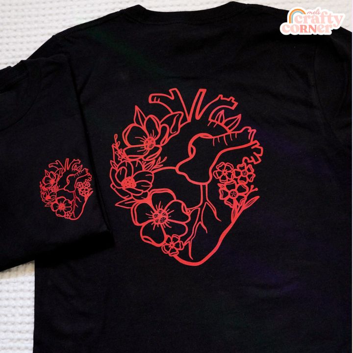 Flat lay view of black Floral Anatomical Heart softest t-shirt by Mel's Crafty Corner