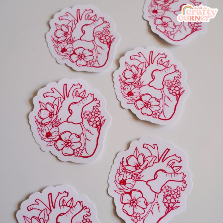Hand holding Floral Anatomical Heart red matte sticker showing size and scale by Mel's Crafty Corner