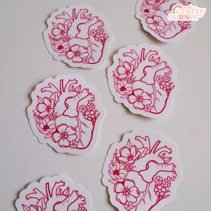 Hand holding Floral Anatomical Heart red matte sticker showing size and scale by Mel's Crafty Corner